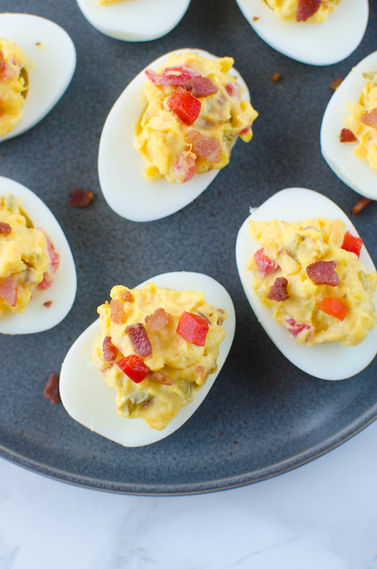 Bacon Pimento Cheese Deviled Eggs - a twist on the classic! Deviled egg filling is mixed with crispy bacon, cheddar cheese, and pimentos. So delicious and the perfect way to use all those Easter eggs!