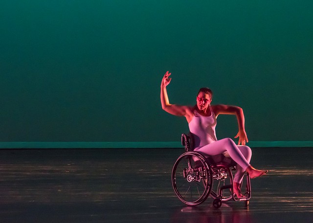 A dancer in a wheelchair performs on stage during Take a Walk in Her Shoes.
