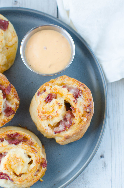 Corned Beef Pizza Rolls - corned beef, swiss cheese, and thousand island dressing rolled up in pizza dough and baked until golden and delicious! Only 4 ingredients and totally addictive!