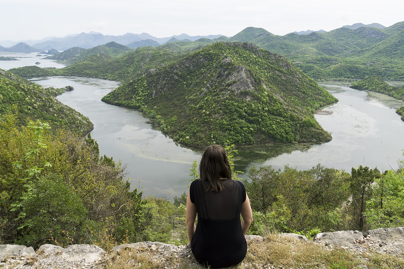 Sitting by the edge of a cliff overlooking Crnojevica River in Lake Skadar national Park | Montenegro | My gluten free experience in Montenegro 