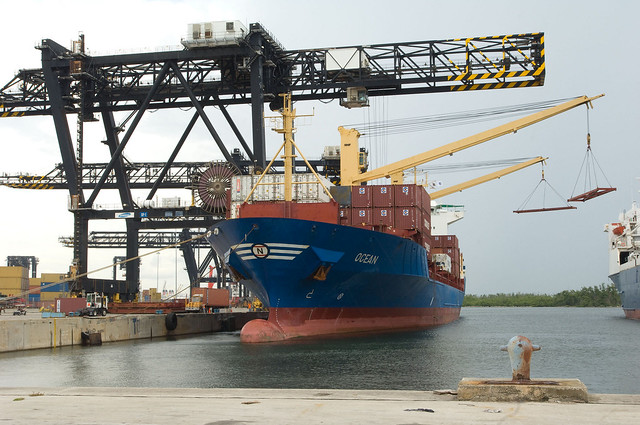 A ship being loaded with agricultural cargo