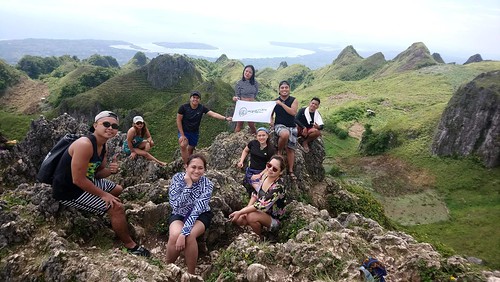 The image shows   Aldri, Michelle, Liz, Jeravy, Shembs, Sergio, Jheng, Gab, and Jhet at the Osmeña Peak sitting while having a group photo.