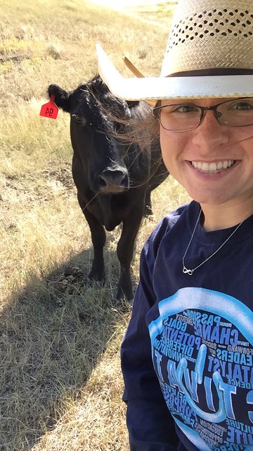 Kelsey Ducheneaux taking a selfie with a cow