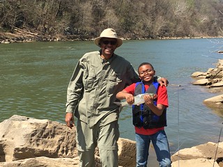Photo of Grandfather and grandson with shad