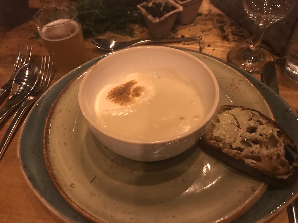 bowl of parsnip soup with toast on the side