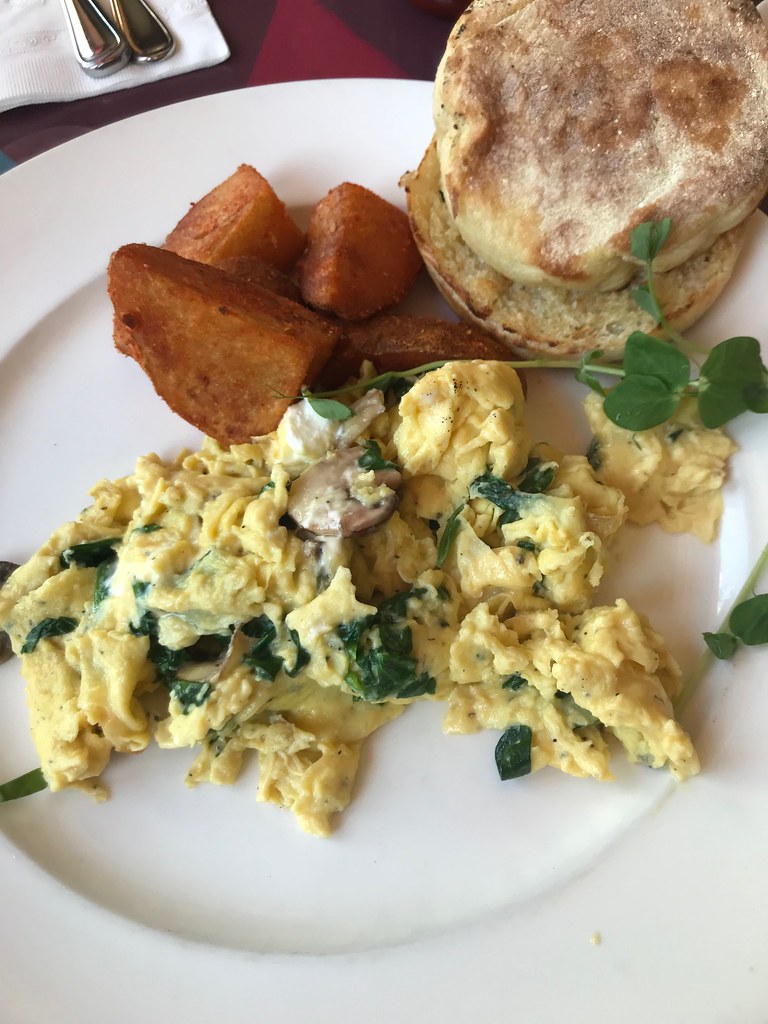 scrambled eggs with herbs and mushrooms, home fries, and english muffins