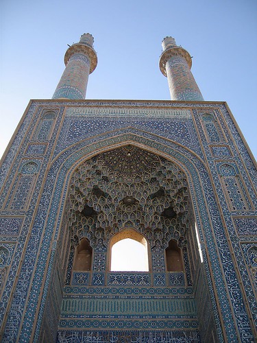 Looking up at the 48m high minarets atop the 15th century tiled entrance to the Jameh mosque, Yazd