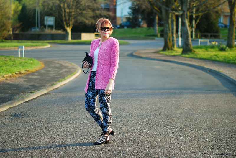 Spring style: Fluffy pink cardigan, paisley joggers, black lace up pointed flats, up do, cat eye sunglasses, evil eye brooch