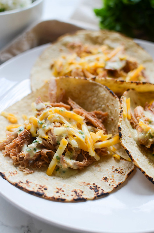 Slow Cooker Sweet Pork Tacos with Cilantro Ranch Dressing - crockpot shredded pork cooked in a sweet and spicy sauce. Use it to make tacos or burrito bowls and top with homemade Cilantro Ranch Dressing!