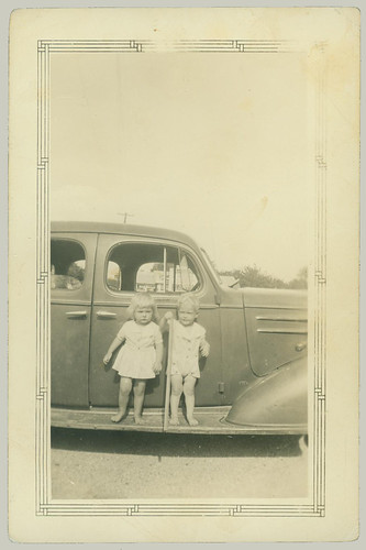 Two children on a running board