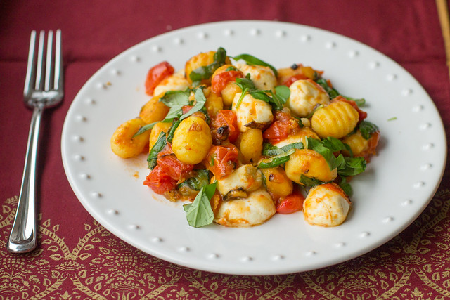 Pan-fried gnocchi with oven-roasted tomatoes, mozzarella, and heaps of fresh basil - perfect cozy date night meal! 