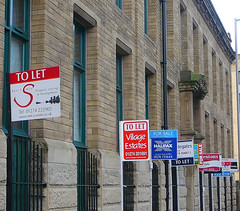 Small rental marketing signages outside a building.