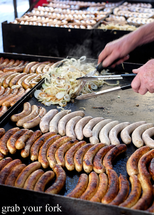 Sausages and onions on the grill at the Salamanca Market in Hobart