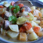 Stew of winter vegetables with fried sausage and parsley