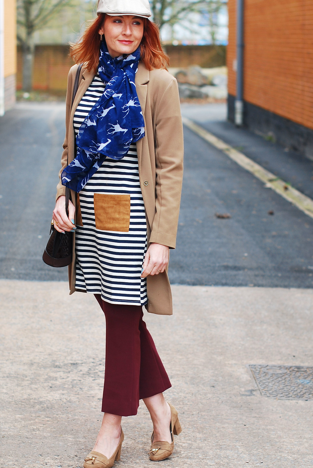Styling a preppy stripe summer dress in autumn/winter: Camel longline blazer stripe tunic dress with patch pockets kick flare burgundy trousers heeled loafers crossbody bag stone flatcap for women | Not Dressed As Lamb, over 40 style
