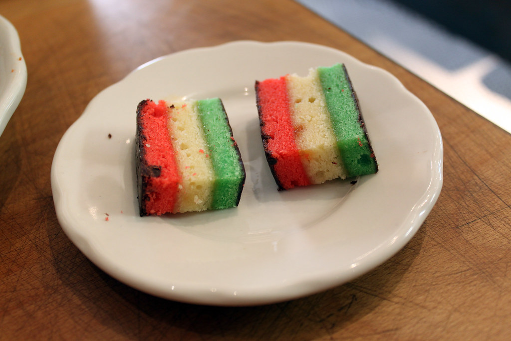 two rainbow cookies in a white dish 