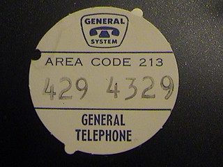 Automatic Electric model 80 number card  with locator tabs which key the location in the dial and a hole for the dial release tab tool