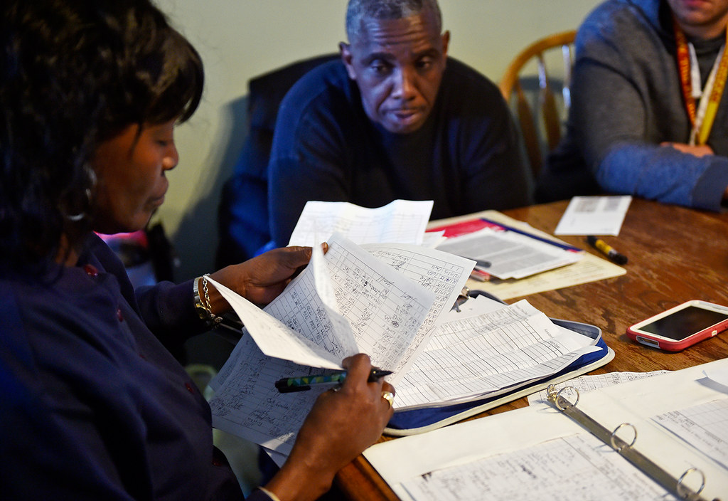 © 2016 by The York Daily Record/Sunday News. Sees-the-Day staffer Beechie King, left, reviews sign-in/sign-out sheets while conducting the weekly house meeting at a Linden Avenue recovery house operated by Sees-the-Day on Sunday, Feb. 28, 2016. Like many other York recovery houses, Sees-the-Day requires its residents to sign in and out when leaving and returning to their respective houses. King said the sheets, which had been neglected by the Linden house residents, are often the first things that probation officers check when meeting with their clients.