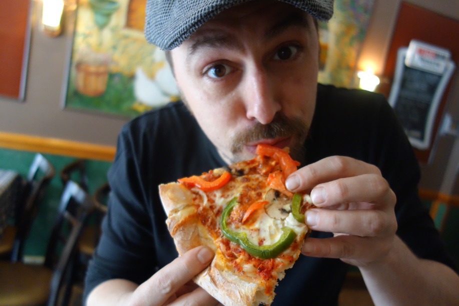 Jason Nadler eats pizza in Parkdale