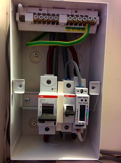 [Metal enclosure with the cover off showing the circuit breakers and Power Meter]
