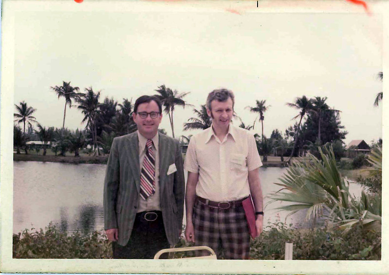 Curt Lidner and Alexander Ross in front of a pond with palm trees a the inaugural Southeaster International Conference on Combinatorics, Graph Theory and Computing