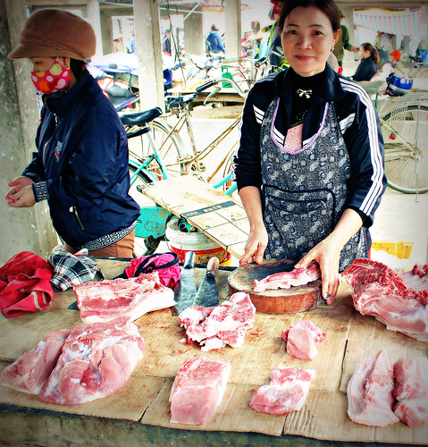 Selling pork in a traditonal Vietnamese market