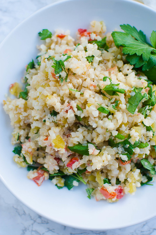 Mexican Cauliflower Rice - delicious low carb and paleo side dish! Cauliflower rice cooked with green chiles, tomatoes, cilantro, and spices! 