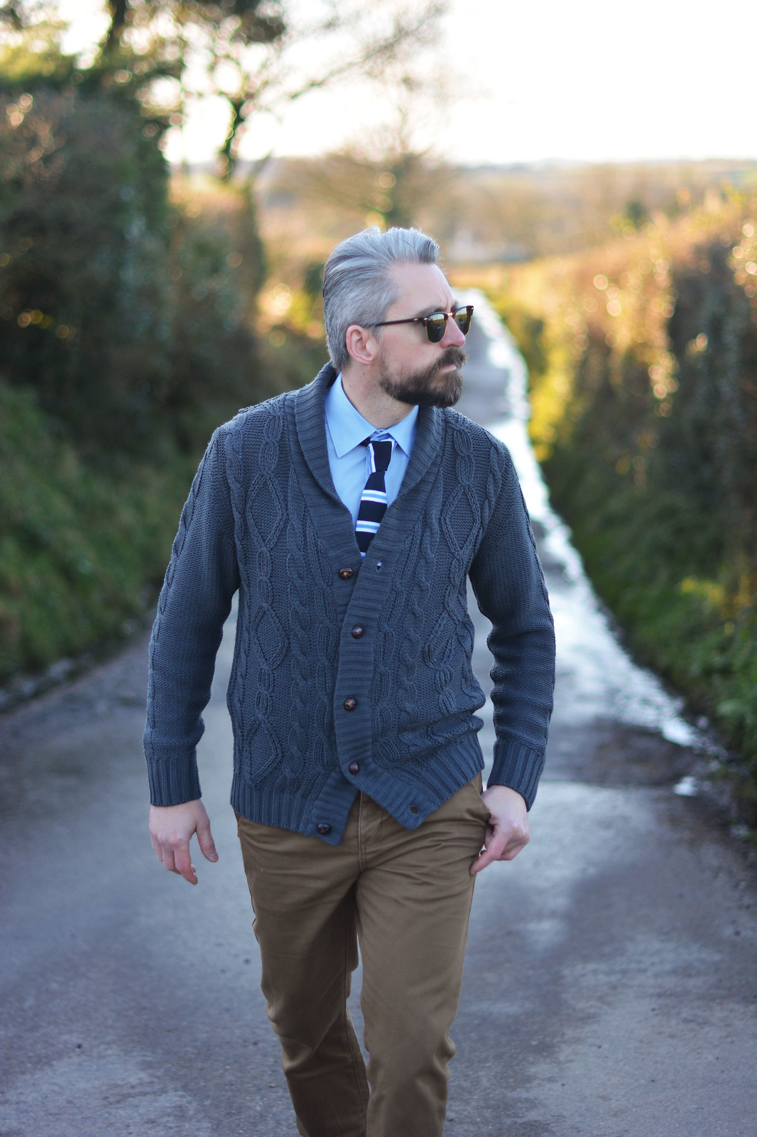 Smart casual menswear: Cable knit cardigan \ shirt and striped tie \ camel chinos \ canvas lace-up shoes \ RayBan Clubmasters | Silver Londoner, over 40 menswear