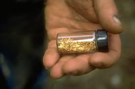 gold vial in hand