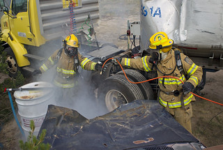 two Emergency responders wearing hazmat suits taking part in an exercise