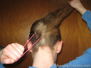 Put in the hair elastic to finish the ponytail - 12 pretty & practical hiking hairstyles