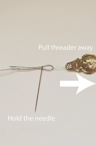How To Thread a Needle: 4 Hold needle and pull threader away from needle