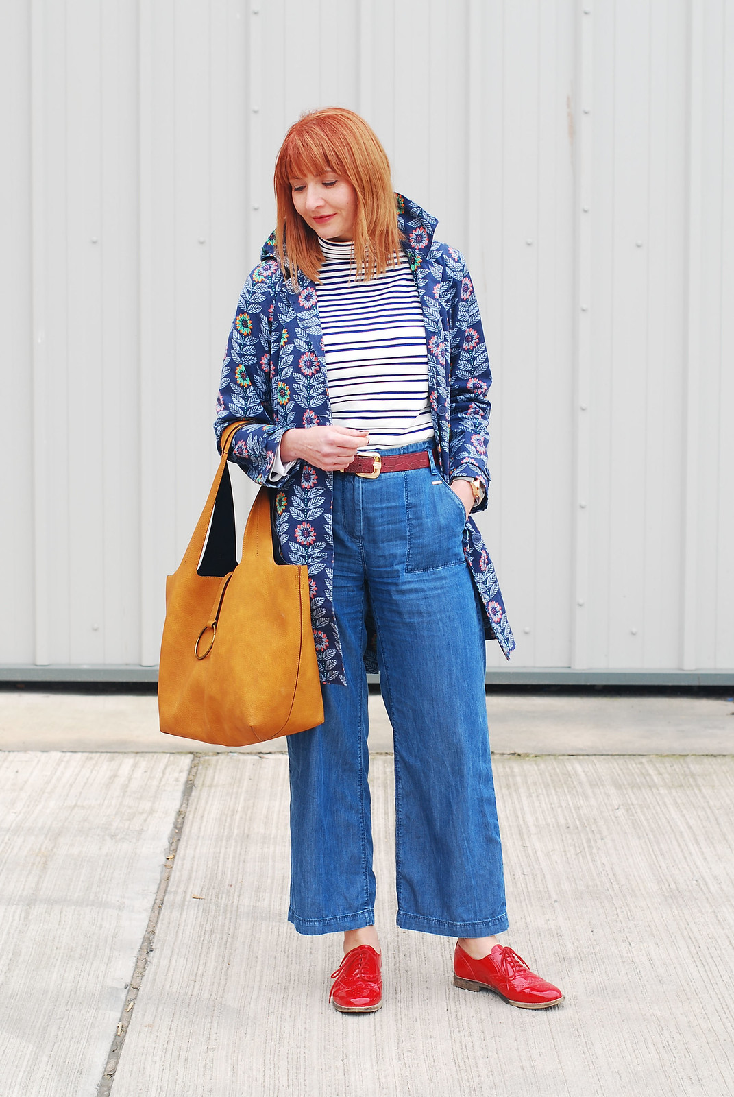 Bright spring weather outfit: Floral Seasalt raincoat high neck stripe Breton top wide leg cotton denim trousers red brogues ochre bucket bag | Not Dressed As Lamb, over 40 style