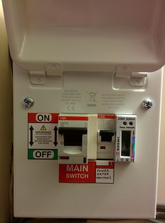 [Metal enclosure with lid open showing 80A and 6A circuit breakers and the Power Meter]