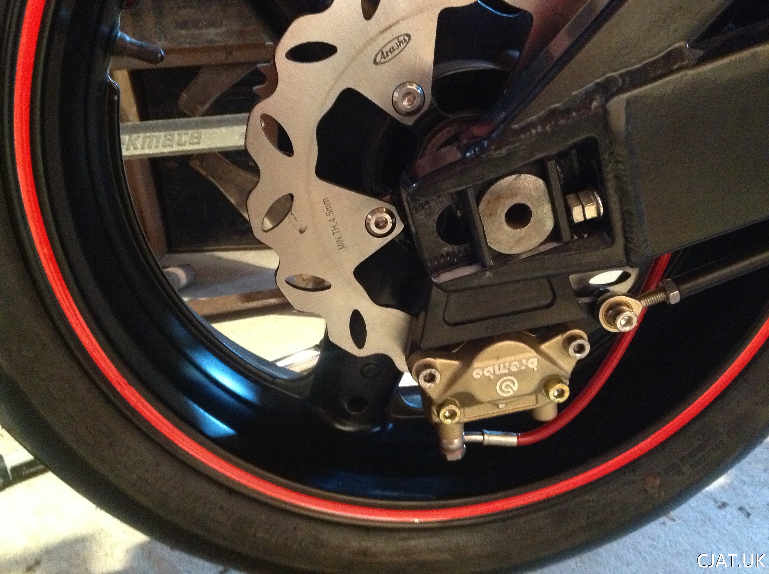 rf900 fitted with brembo rear brake and braided red brake line with wavy disk brake