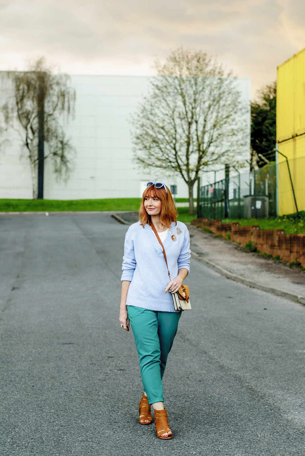 Spring look: Pale blue sweater emerald green peg trousers flower brooches tan strappy block heeled sandals two tone cross body bag | Not Dressed As Lamb, over 40 style
