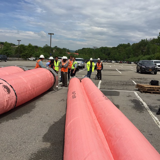 Metro-North personnel attend a demonstration of a portable floodwater retention system.