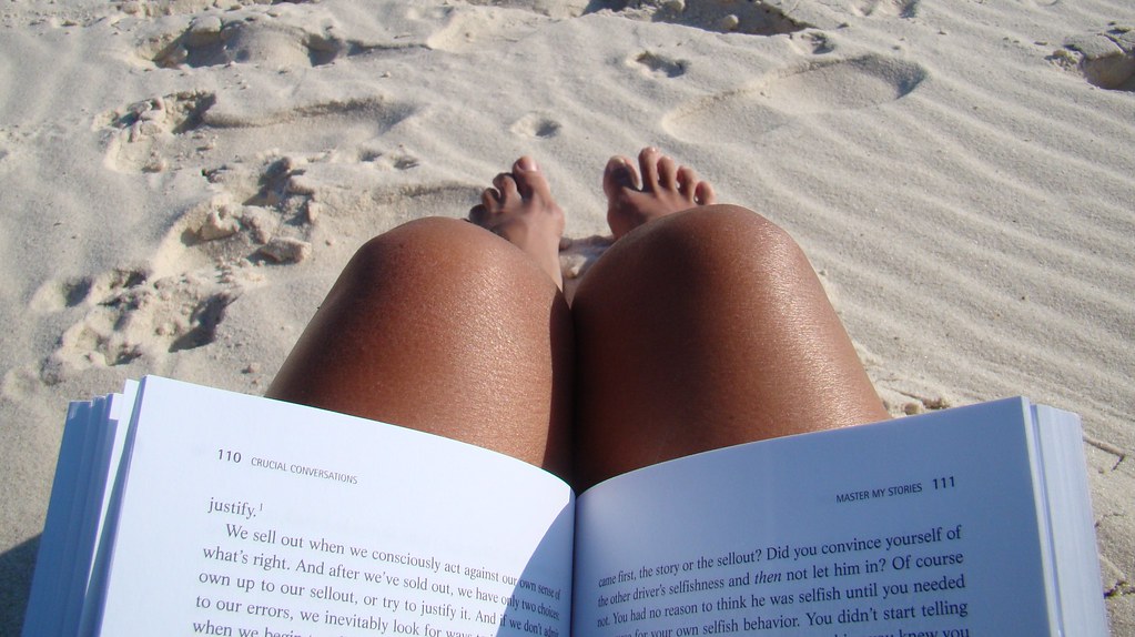 Woman reading a book at the beach
