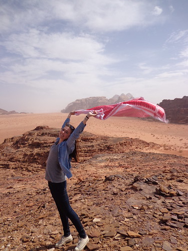 Keffiyeh in the Wind: A student holds a keffiyeh above her head as it blows in the breeze in Wadi Rum, Jordan.