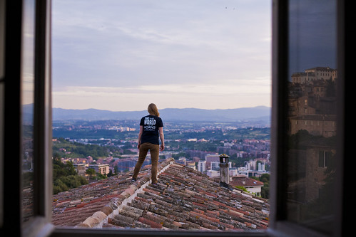 Rooftops: A student stands on a rooftop at sunset, overlooking Perugia, Italy.