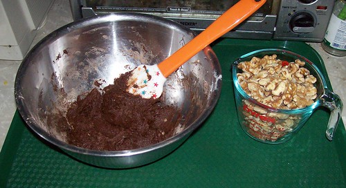 cookie batter bowl with nuts beside it