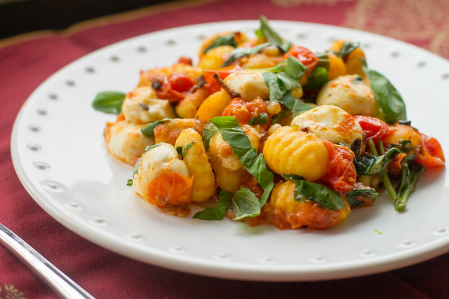 Pan-fried gnocchi with oven-roasted tomatoes, fresh basil, and mozzarella - perfect for a little indulgence or date-night meal!