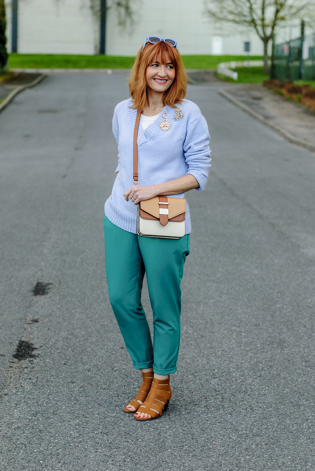 Spring look: Pale blue sweater emerald green peg trousers flower brooches tan strappy block heeled sandals two tone cross body bag | Not Dressed As Lamb, over 40 style