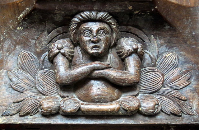 An angry woman: 16th C. misericord, the Collegiate Church of Notre-Dame (Collégiale Notre-Dame), Le Puy-Notre-Dame, Anjou, France