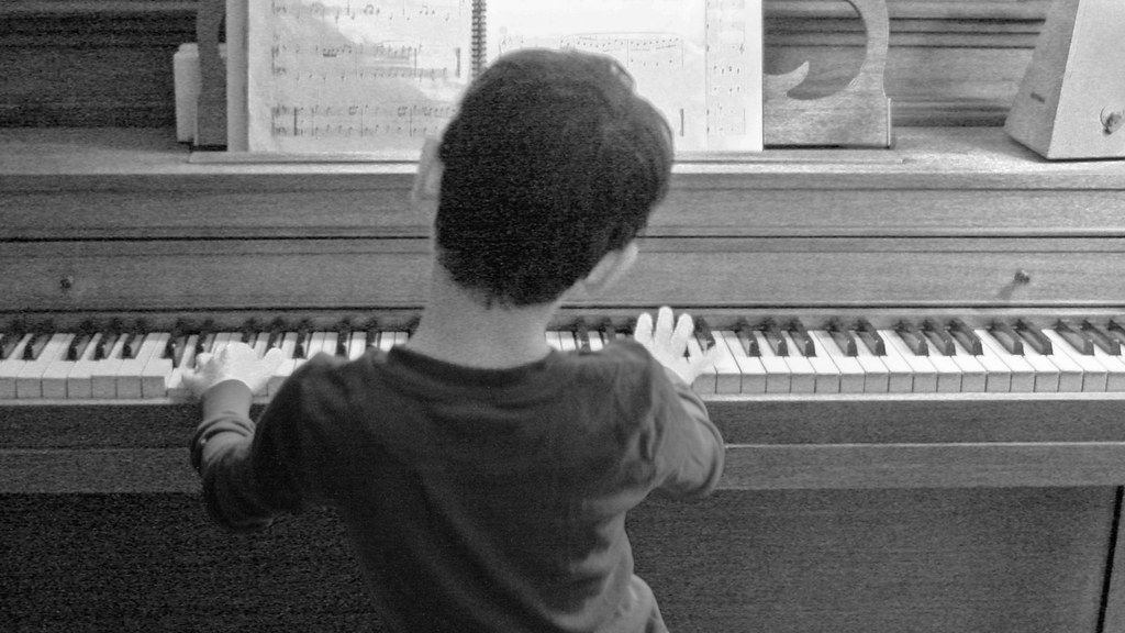 Young boy playing the piano