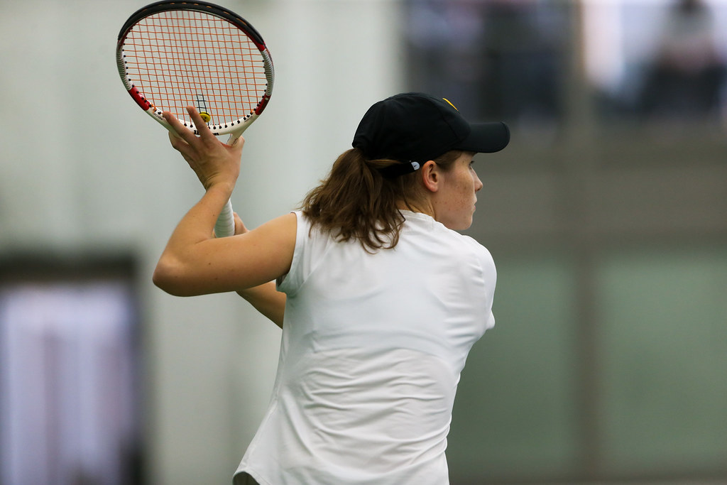 Elise van Heuvelen prepares to return a shot during the doubles tennis match.