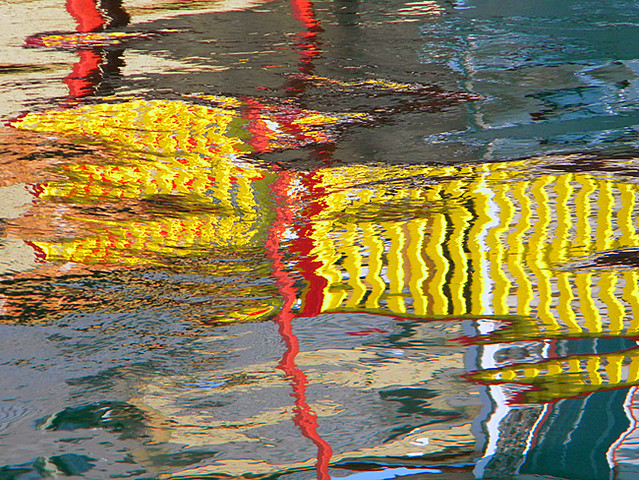 reflection of yellow fence on the water