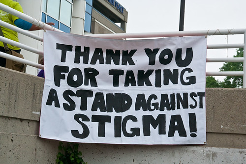A sign hanging from a railing that reads, “Thank you for taking a stand against stigma!”