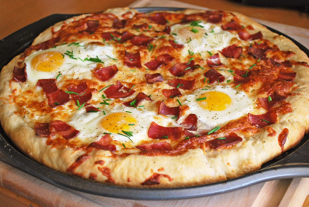 Breakfast Pizza - pizza with bacon, 2 kinds of cheese, runny eggs, and chives on top! Perfect for breakfast for dinner!