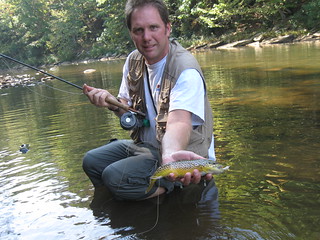 Photo of man holding a brown trout
